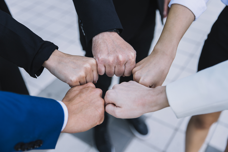 Colleagues give each other a fist bump