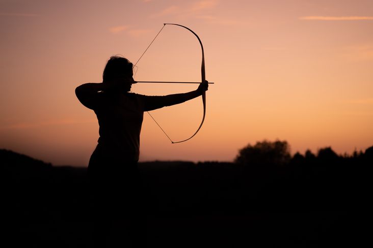 Woman aims with a bow