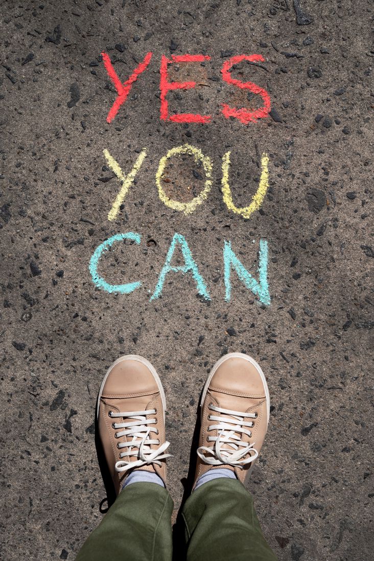 Inspirational quote “Yes, you can” written in concrete