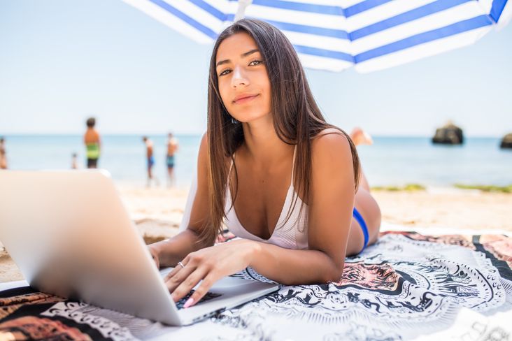 Brunette working on the beach