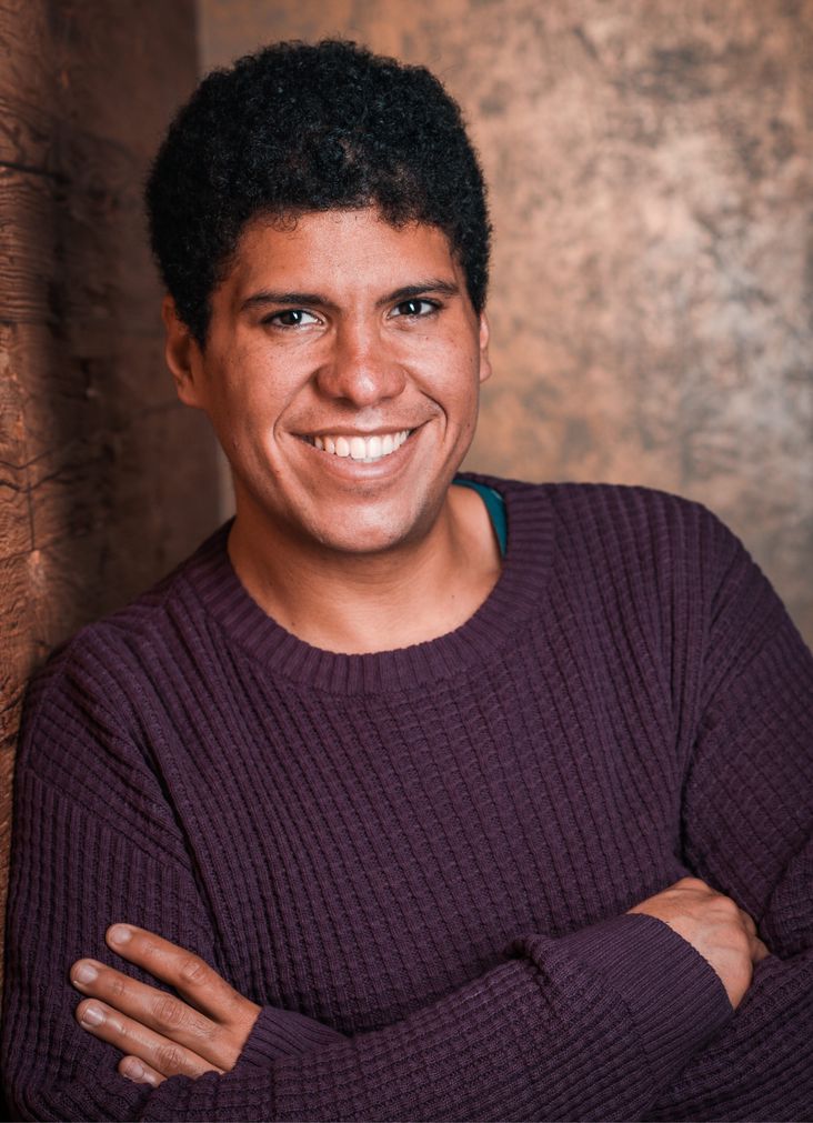  Dr. Urbina-Blanco standing, smiling, looking at the camera with his arms crossed