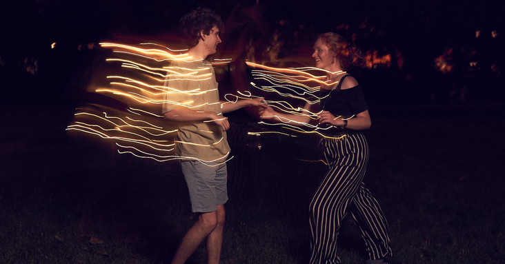 Couple dancing at night, light effect