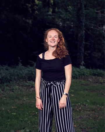 Redhead, smiling in the park