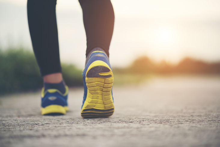 Close-up photo of a woman’s shoes while jogging